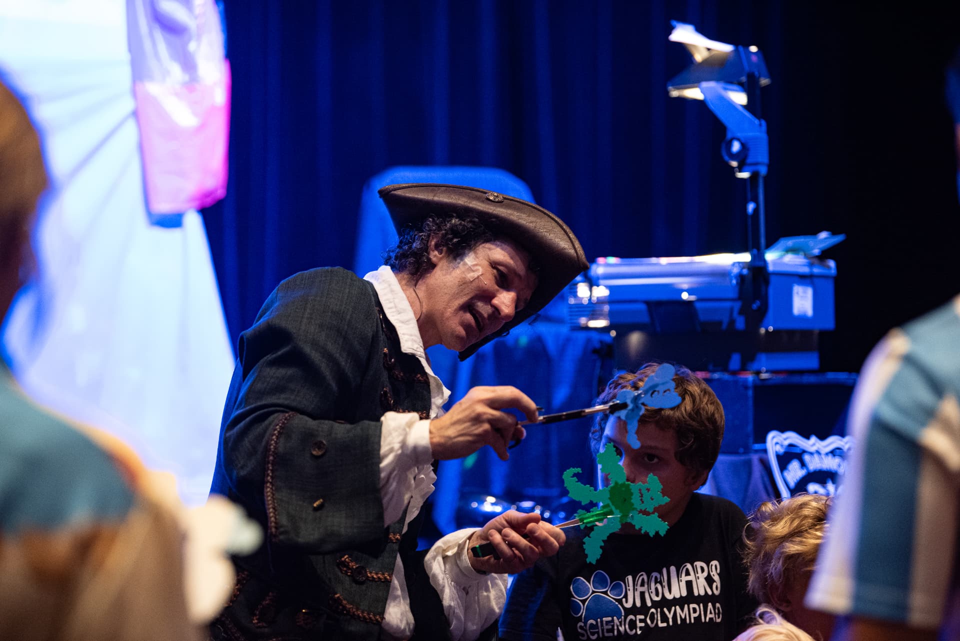 Mr. Damon performing with shadow puppets alongside a young audience member